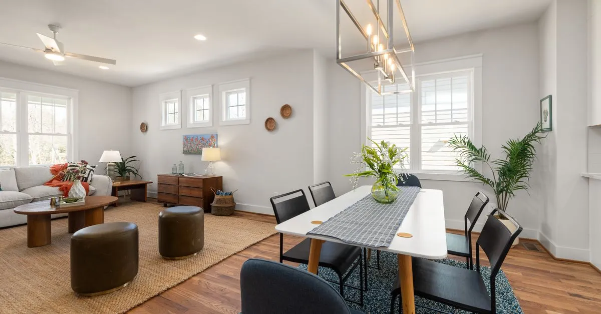 Bright and cozy living and dining area with modern decor and natural lighting.