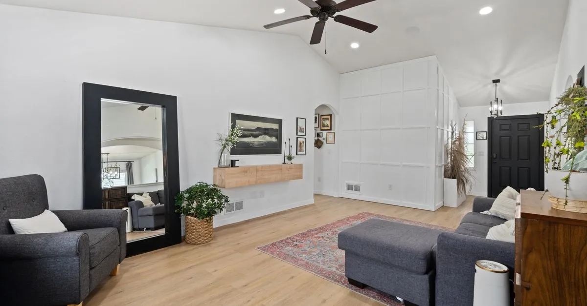 Spacious, stylish living room featuring modern furniture, decor, and lighting for a cozy and elegant atmosphere.